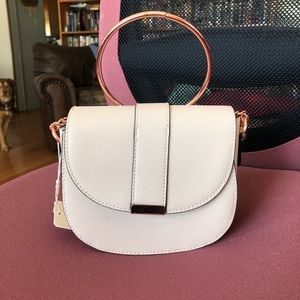 Cream crossbody with rose gold details.